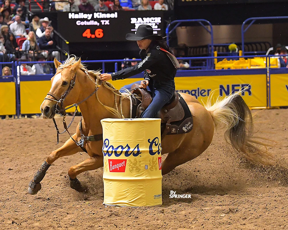 Hailey Kinsel and Sister rounding a barrel at the 2024 Wrangler National Finals Rodeo