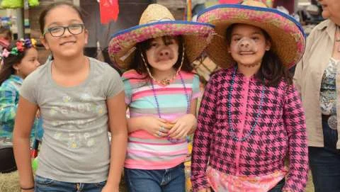 Children wearing sombreros and pig noses at a festival, from the Cotulla fair listing